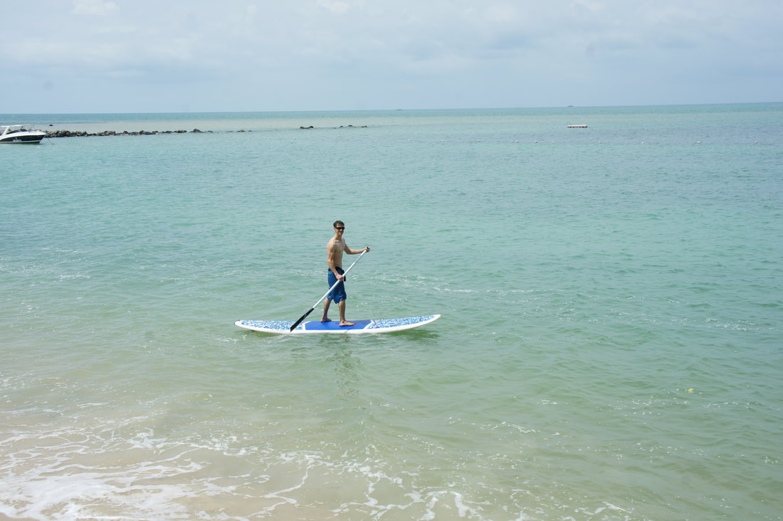Sam on an SUP (stand-up paddleboard) in the Gulf of Thailand